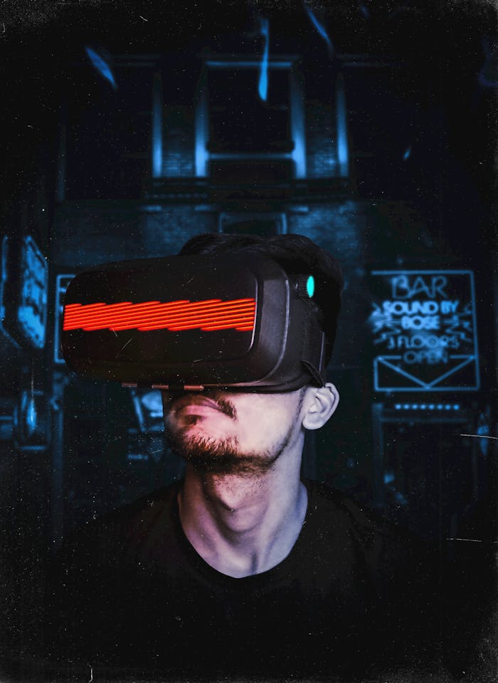 classes-03 Young man immersed in a virtual reality experience using a VR headset, showcasing futuristic tech in a gaming environment.